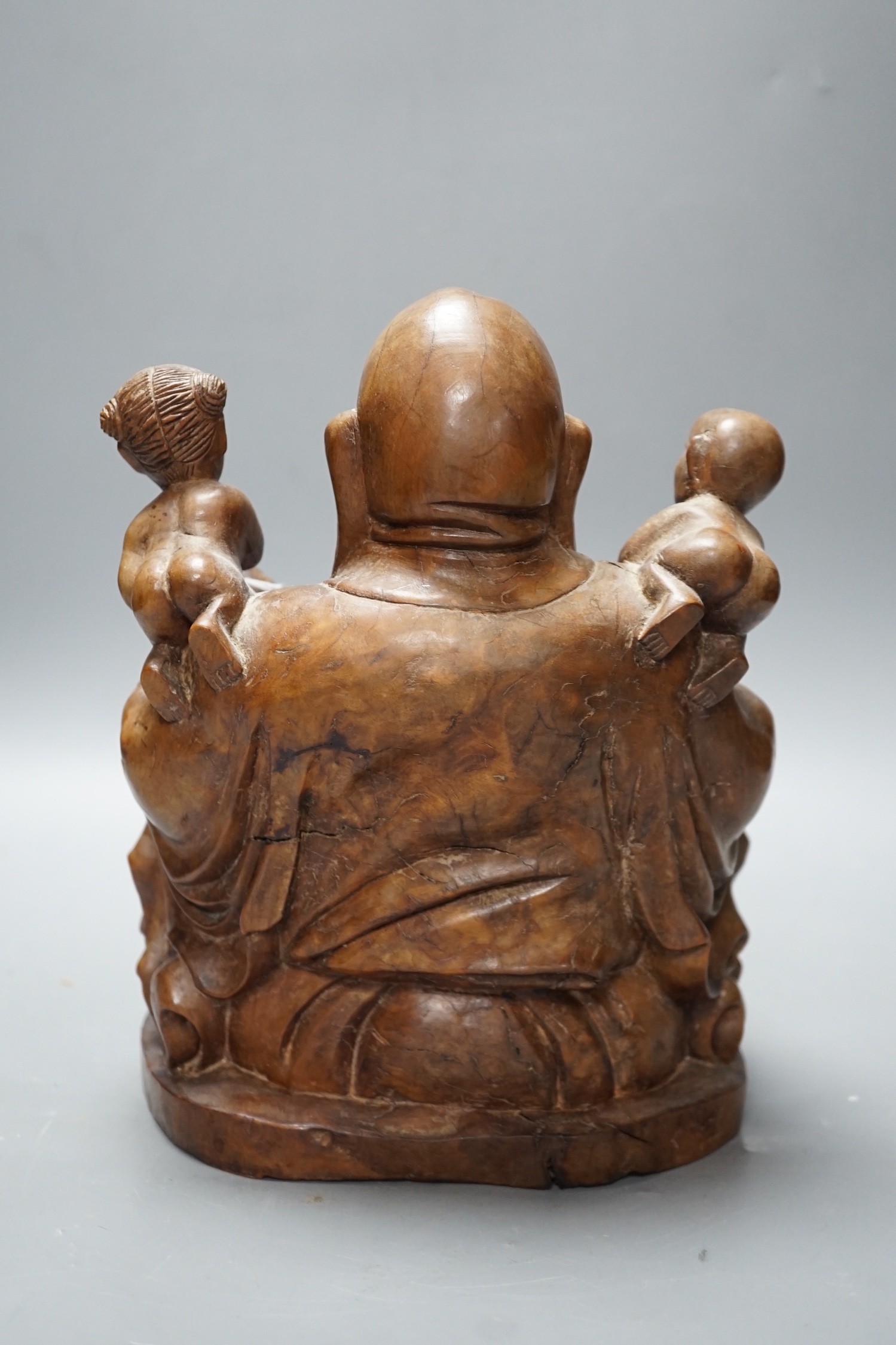 A Chinese carved wood group of Budai, 24cm